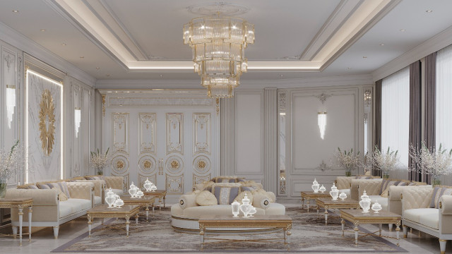 This picture shows an elegant and luxurious dining room designed with heavily ornate furniture and decorations. The walls are upholstered in a white and gold velvet, while the floor is covered in a beige marble tile. At the center of the room, a large wooden table with curved legs is surrounded by light pink velvet chairs with golden details. A large crystal chandelier hangs from the ceiling above the seating area, illuminating the room with a warm, flattering light. Various other antique furniture pieces and decorative items, such as a grandfather clock and wall art, can be seen throughout the space
