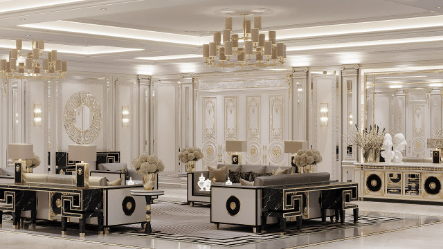 This picture appears to show an ornate and luxurious interior design. There is a large crystal chandelier hanging from the ceiling, and the walls are decorated with various wall hangings and gold-colored accents. The floor is a tiled mosaic in shades of black, grey, and white, and the furniture includes several elegant sofas and armchairs upholstered in dark fabrics. Additionally, there is a grand, marble-topped table in the center of the room as well as a variety of sculptures and vases throughout.