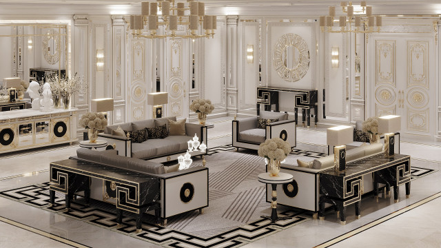 This is a picture of a luxurious and elegant living room. It features a cream-colored couch with beige cushions, a round glass coffee table, a large rug with an ornate pattern, several pieces of art decorating the walls, and two elegant gold lamps on either side of the couch. There is also a white plant in the corner adding a touch of greenery and life to the space.