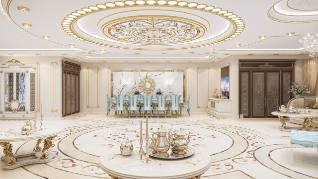 Luxurious entrance hall with grand staircase illuminated by ornate crystal chandelier and adorned with marble columns.
