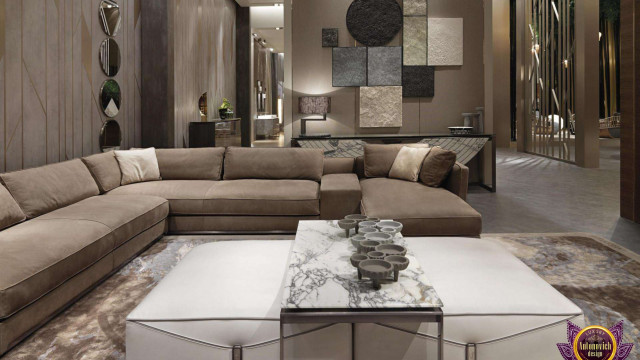 This picture shows an interior design of a contemporary living room with several luxurious and modern furniture pieces. There are two black leather sofas, a white pedestal table, and a round marble table with a chrome base. The walls are painted gray and feature large, abstract wall art. There is also a plush, patterned rug and several potted plants for decoration.