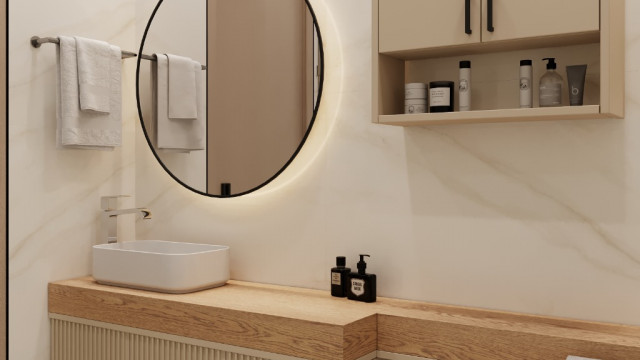 This picture shows a luxury modern bathroom with a contemporary free-standing tub, white marble tiled walls, and a black marble countertop. There is a single sink installed above the countertop and wall-mounted faucets. The room is illuminated by an elegant chandelier and wall sconces. On the left side of the room, there is an open shower area with a glass enclosure and a rain shower head.