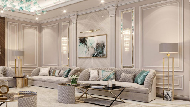 This picture shows a luxurious, modern living room display. It features white furniture with marble accents, a plush velvet sofa, and a glass top coffee table with mirrored side tables. The white walls are accented by a large statement mirror, and there is a statement chandelier hanging from the ceiling that adds a touch of glamour to the room.