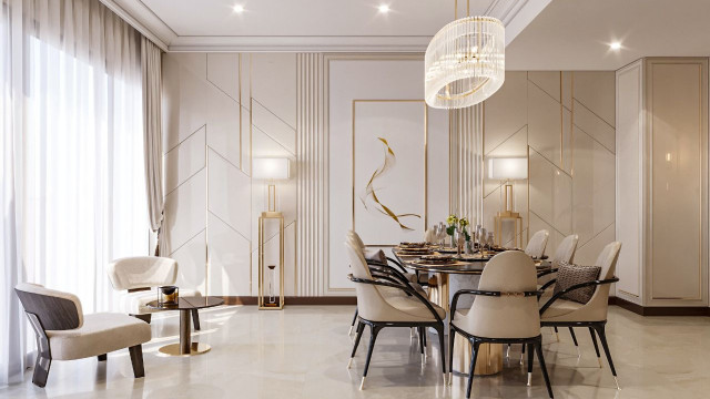 This picture showcases a modern and luxurious interior design. It includes a large crystal chandelier hanging from the ceiling, cream colored walls, white tiled floors, a large glass wall with a view of the outdoors, and an intricately carved cream leather sofa with a matching curved armchair. Various pieces of art and sculptures are displayed on white marble side tables and atop a sleek black grand piano. An ornately decorated round rug grounds the space and adds a touch of refinement.