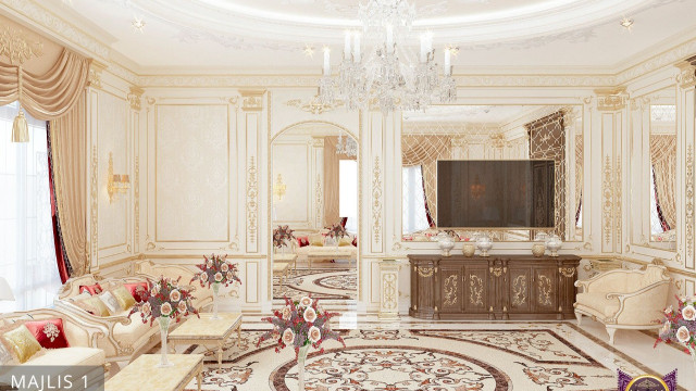This is a picture of an elegant, modern home interior. The room features a white marble floor with a patterned geometric rug in the center. To the left of the room is an ornate, curving cream colored sofa with gold accents on the arms and legs. The walls are painted white with a turquoise strip along the top. On the right side of the room is an ornate, mirrored book shelf filled with art books and decor. In the center of the room is a small, round glass coffee table surrounded by four light colored armchairs. This room looks cozy and