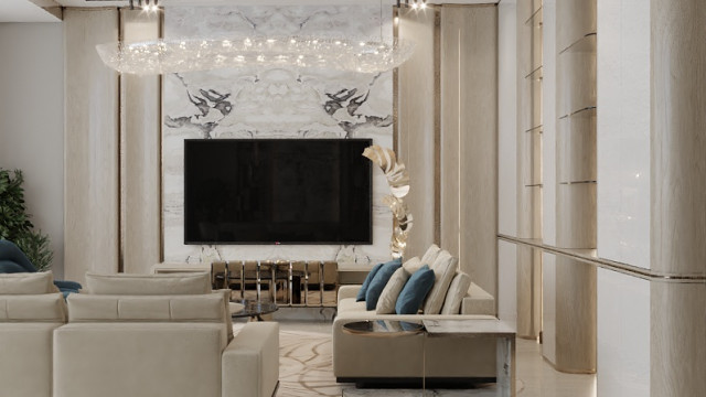 Modern interior of a luxurious room with a dark hardwood floor and white walls. Stylish furnishings include a plush seating area, large ornate mirror, and a chandelier.