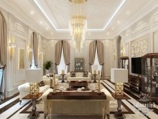 A vibrant, luxurious living room featuring a white sectional sofa and gold crystal chandelier with a modern touch.