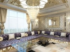 A luxurious living room featuring cream color walls, an elegant black grand piano, and a chandelier overhead.