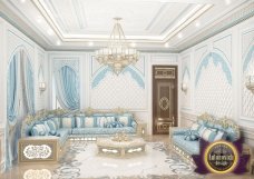 Modern and luxurious living room with a large U-shaped sofa, exquisite chandelier, and beautiful art piece.