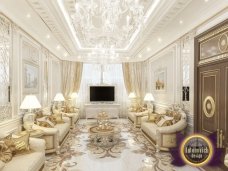 Modern luxury living room features golden furniture, textured walls and warm ambient lighting, perfect for entertaining guests.