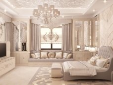 Beautiful white spacious living room with dark flooring, comfortable furniture and a grand chandelier.