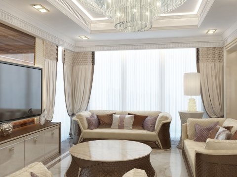 This picture shows a beautiful grand living room designed with a modern luxury aesthetic. The room features elegant furnishings including a large white sectional sofa upholstered in soft beige fabric, two ornate chairs upholstered in luxurious cream velvet, and a polished marble coffee table. The walls are adorned with large golden-framed artwork, and textured wall panels. An ornate chandelier hangs from the center of the ceiling, adding an extra touch of glamour and sophistication to the room.